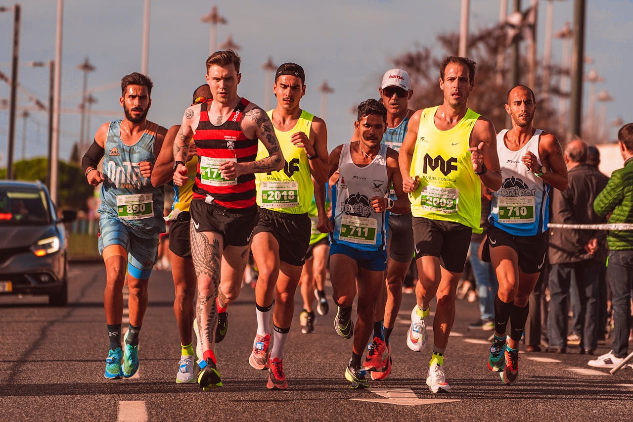 A diverse group of male runners competing in an outdoor marathon race, showcasing athletic endurance and team spirit.