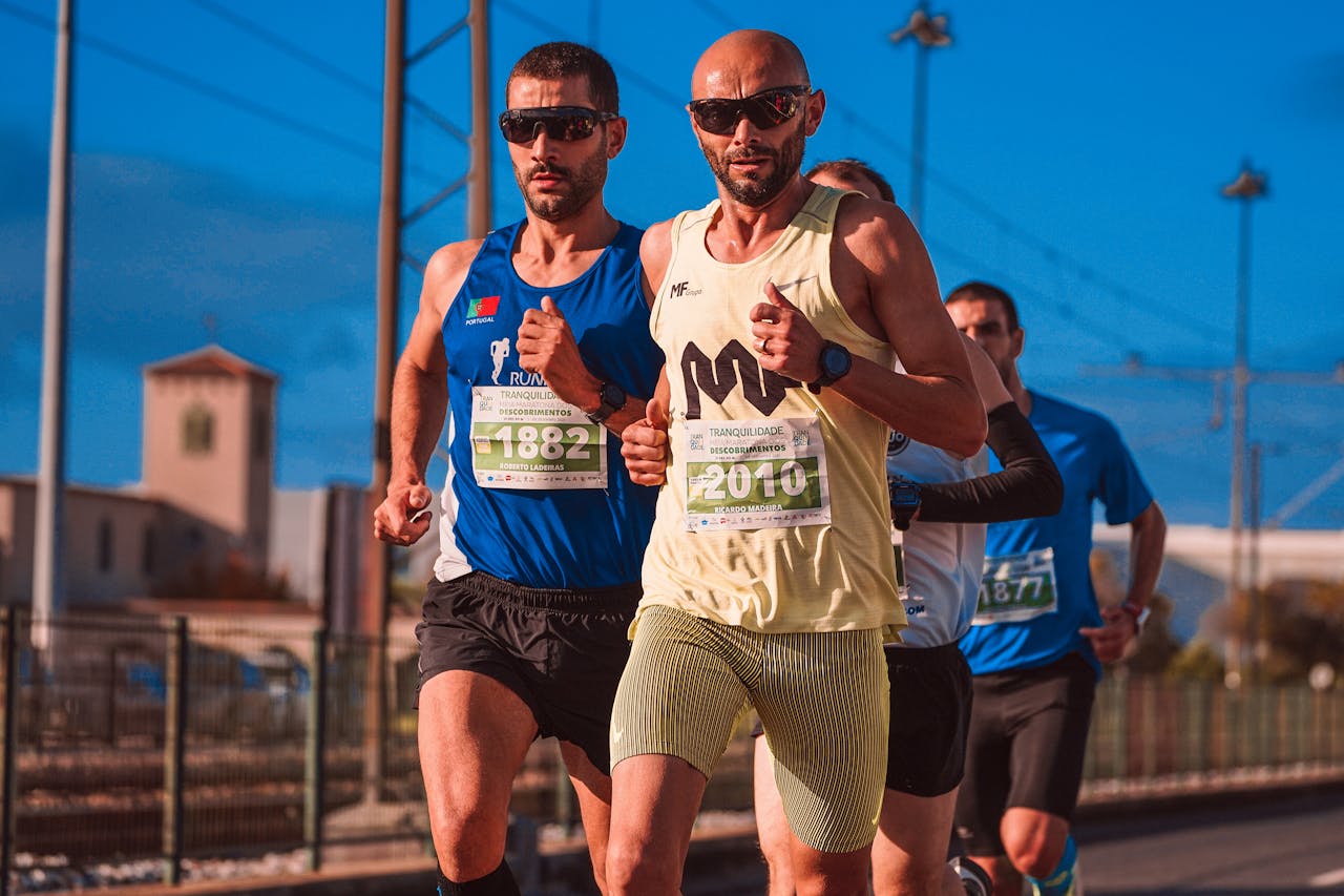 Male athletes compete in an intense marathon race, showcasing endurance and determination outdoors.