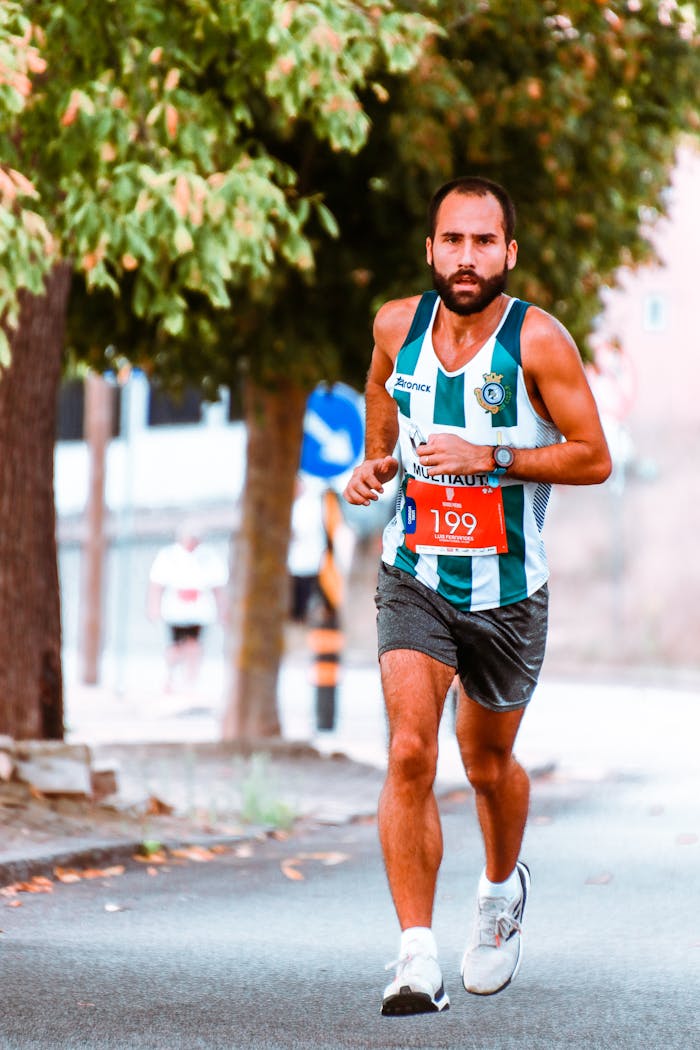 Male athlete running in a vibrant marathon race, showcasing focus and endurance.